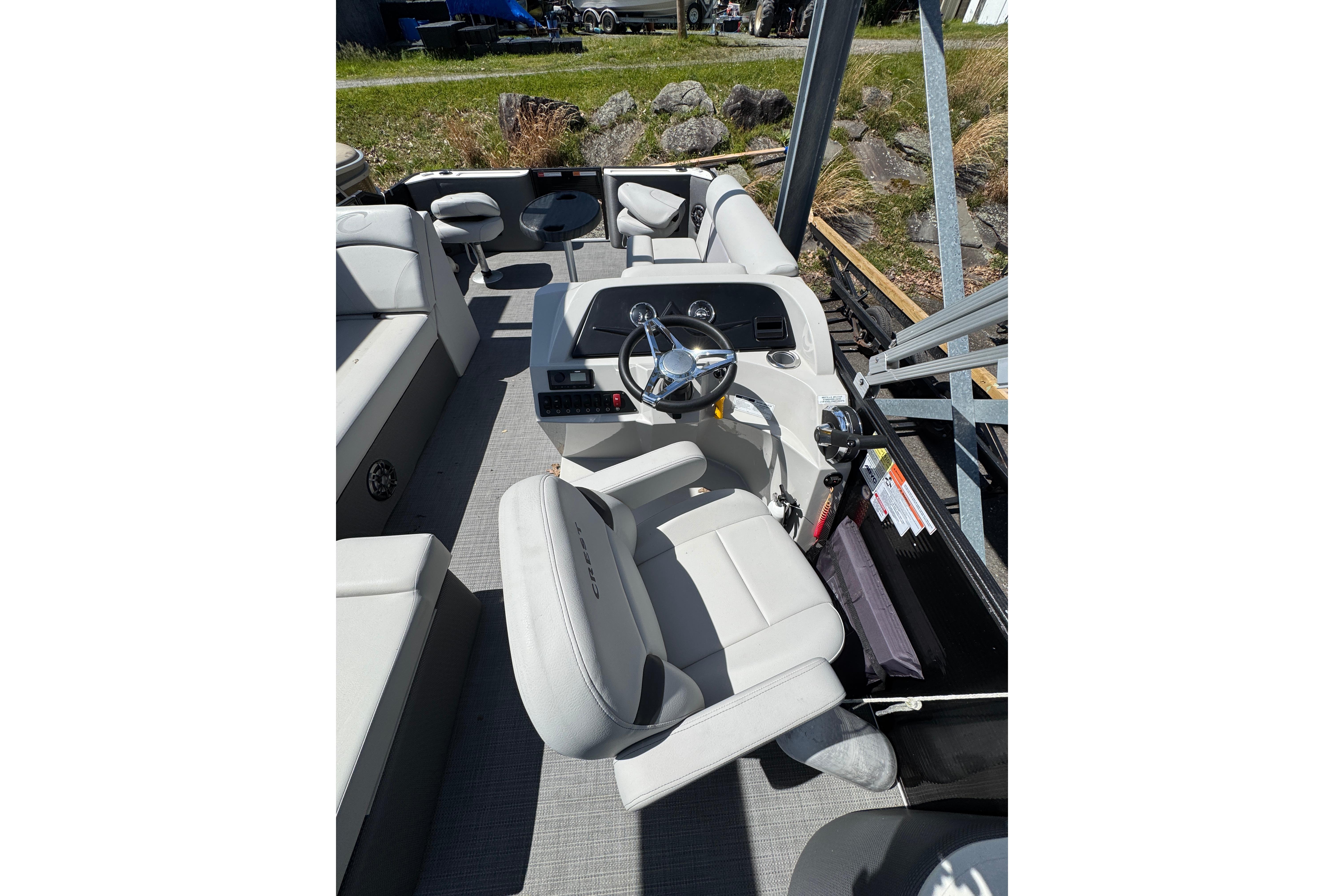 2023 Crest CLASSIC LX FISH 200 C4 boat interior with steering wheel and seating.