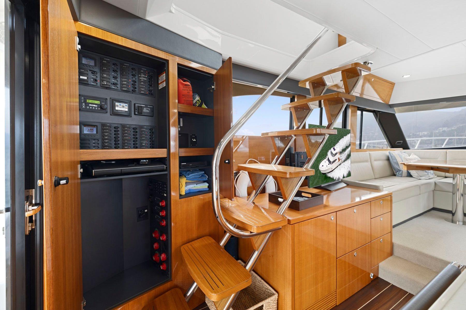 Interior of 2014 Maritimo M50 yacht featuring wooden cabinetry and modern staircase design.