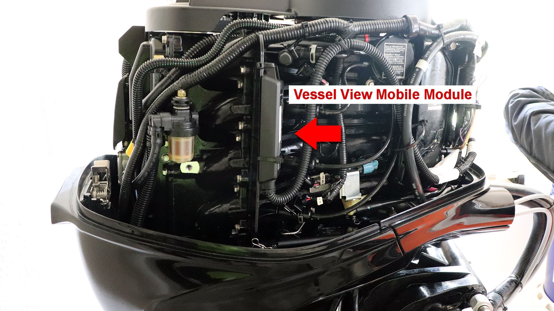 Close-up of a boat outboard motor with visible wires and components.