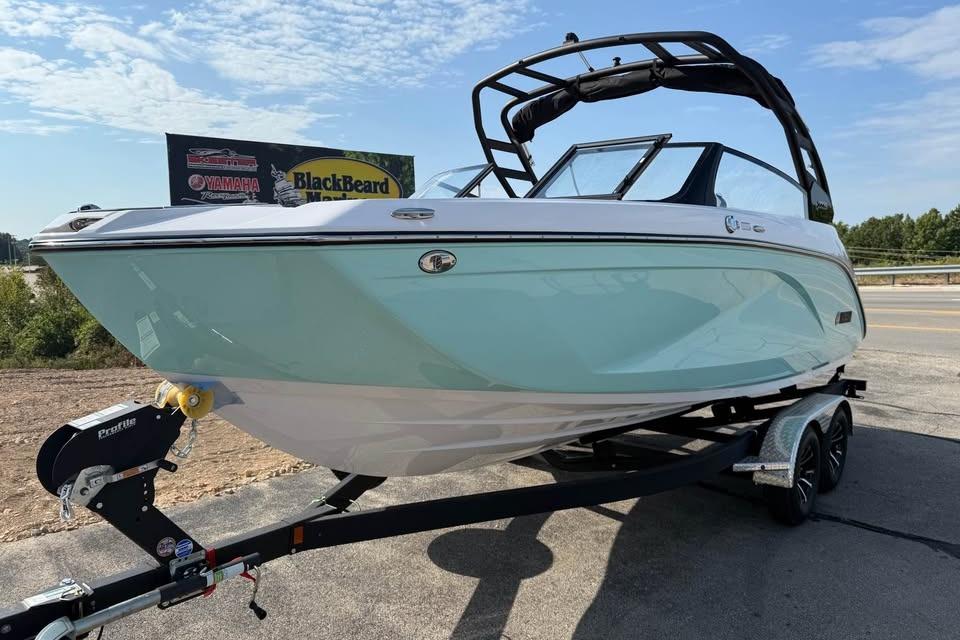 2026 Yamaha Boats 222S on trailer, sleek design, light blue hull, sunny day.
