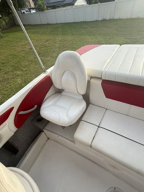 Interior of a 2012 Bayliner 184 SF boat with white and red seating.