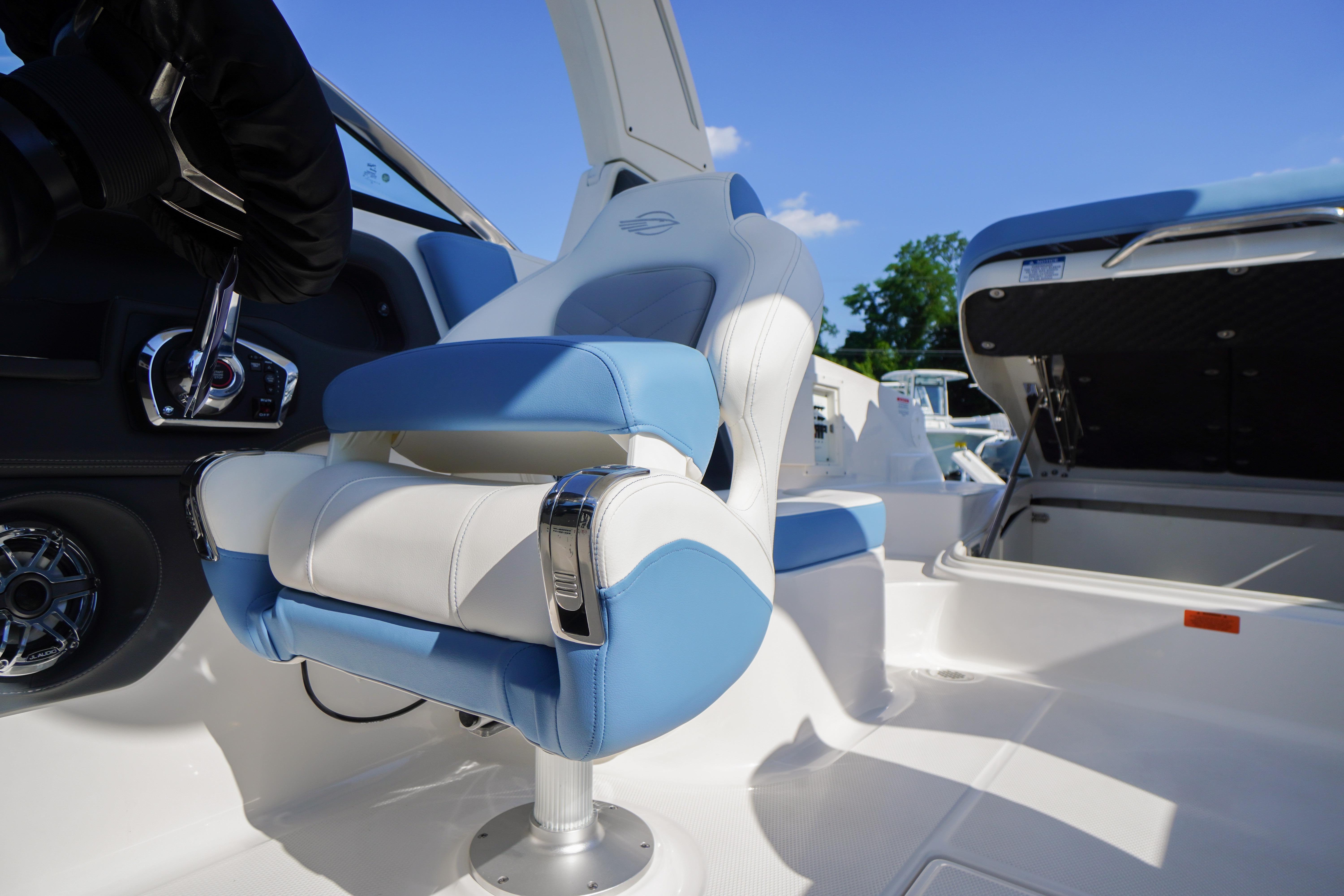 2026 Chaparral 270 OSX boat interior with blue and white seating, showcasing luxury design.