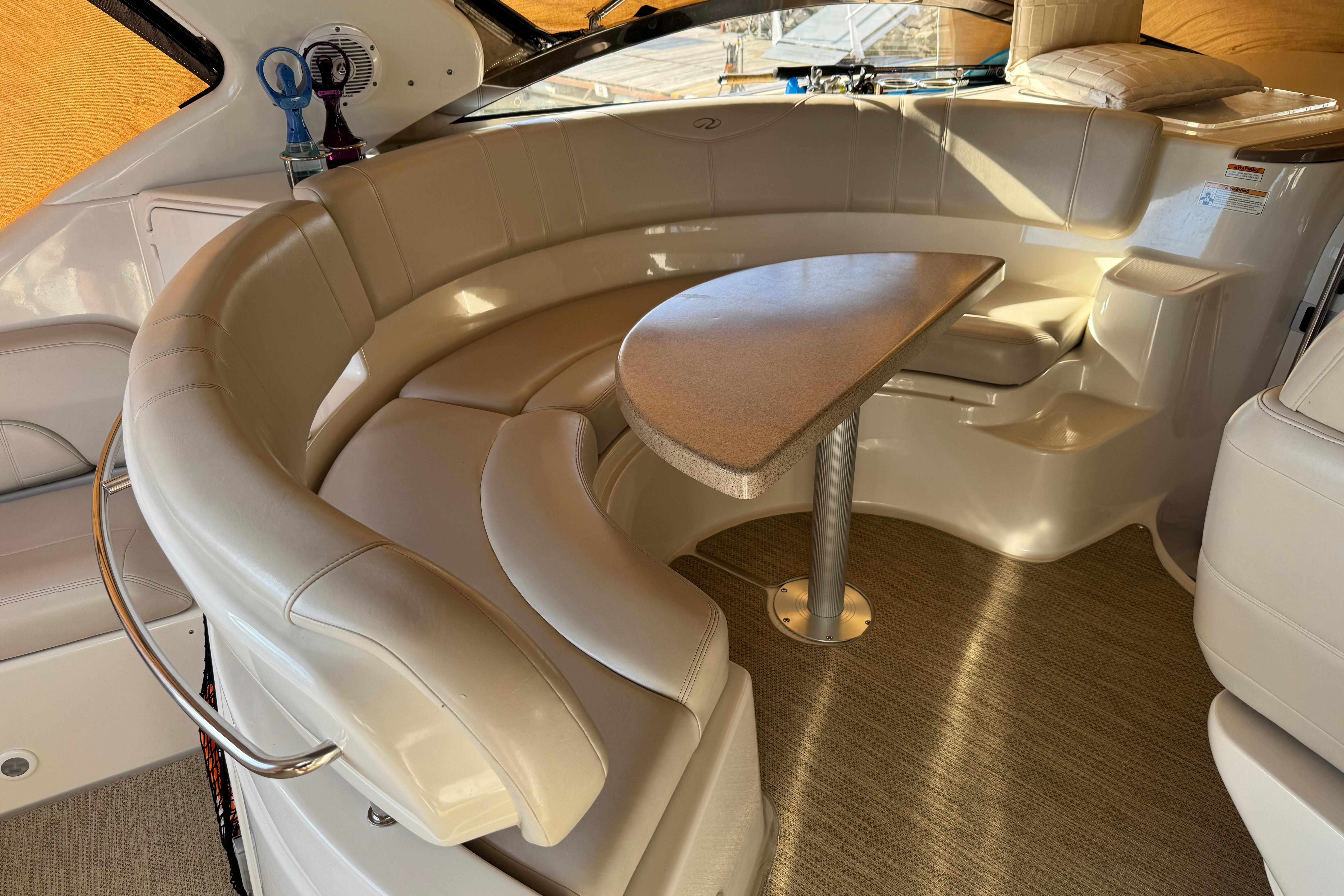 Luxurious interior of 2007 Regal Commodore 3860 yacht with curved seating and table.