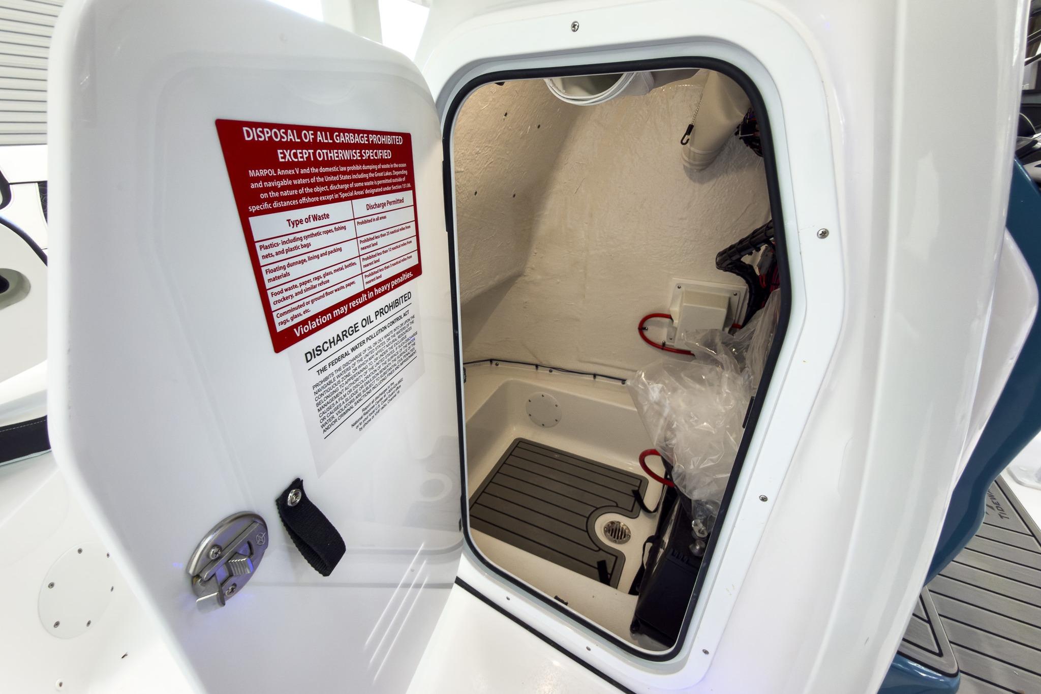 Interior view of a storage compartment with warning notices on the door.