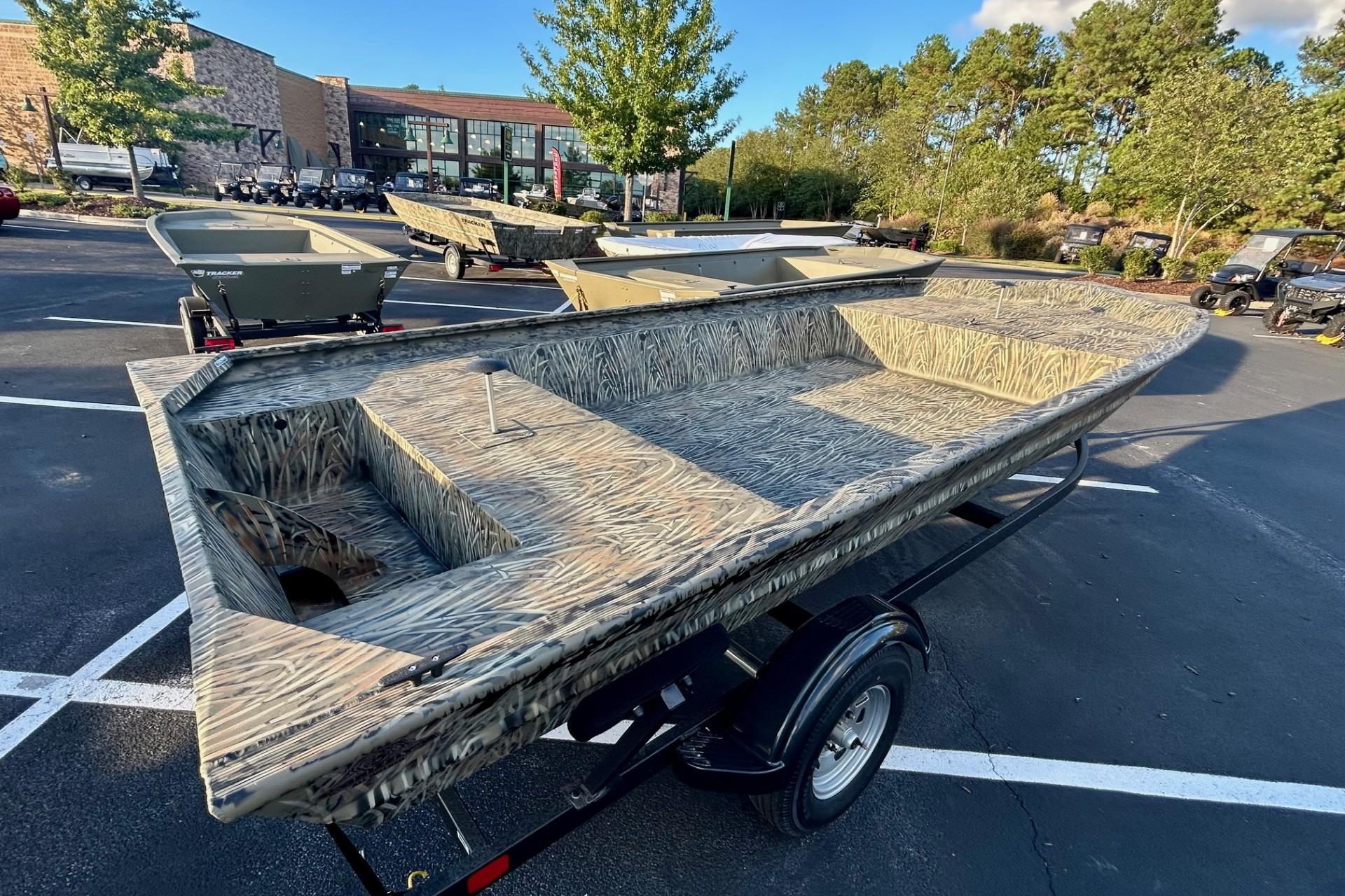 2026 Tracker Grizzly 1860 Utility boat with camouflage design on a trailer.