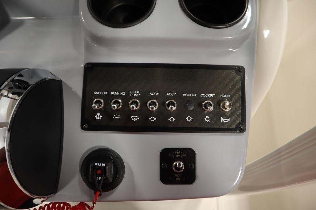 Control panel of 2026 Bayliner Trophy T20CC boat with switches and cup holders.