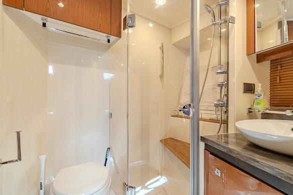 Luxurious bathroom in 2016 Sea Ray Sundancer 510 yacht with modern fixtures and glass shower.