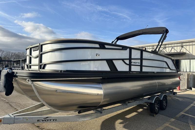 2026 Evotti 523CS pontoon boat on trailer, sleek design, parked outdoors.