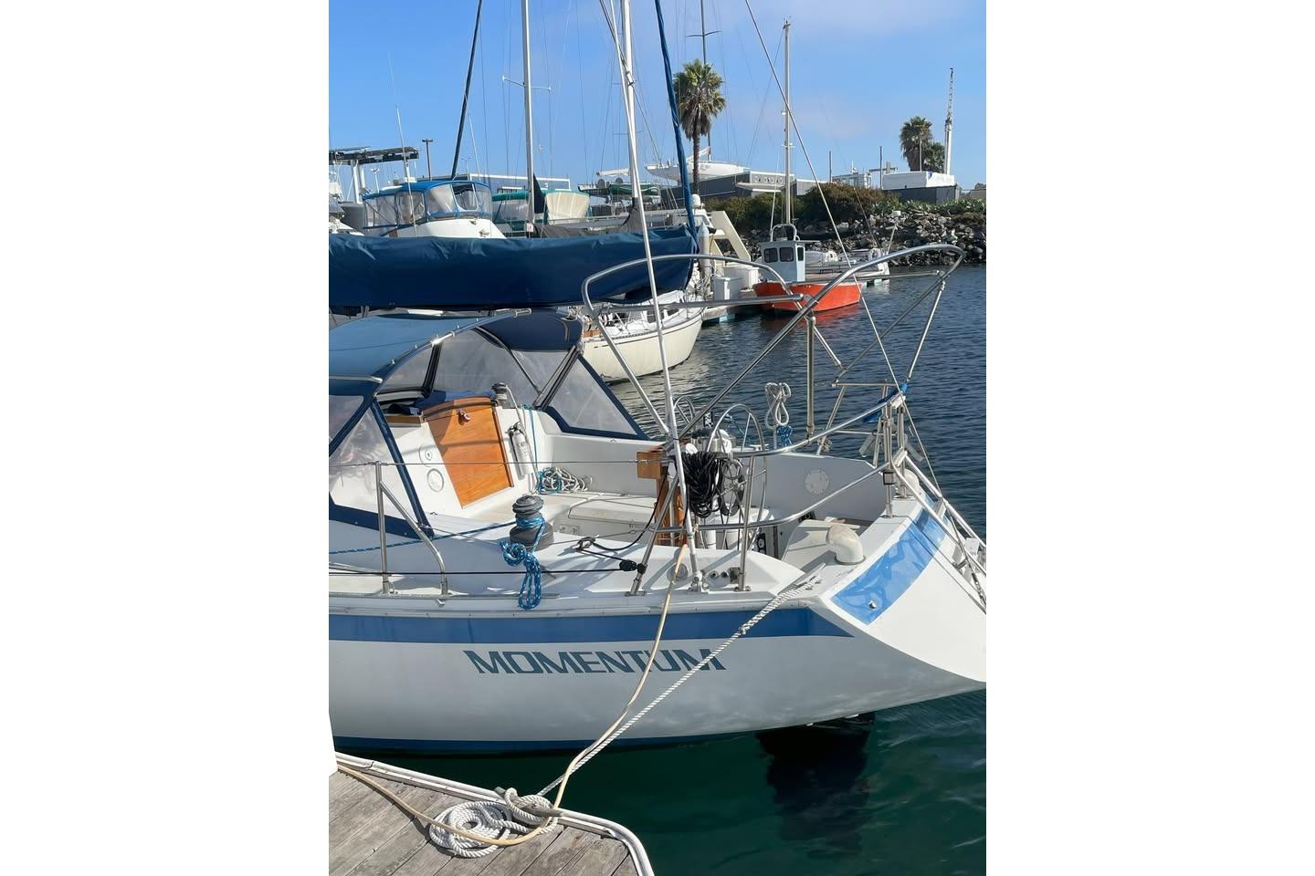 1986 Ericson 381 sailboat named "Momentum" docked in a marina.