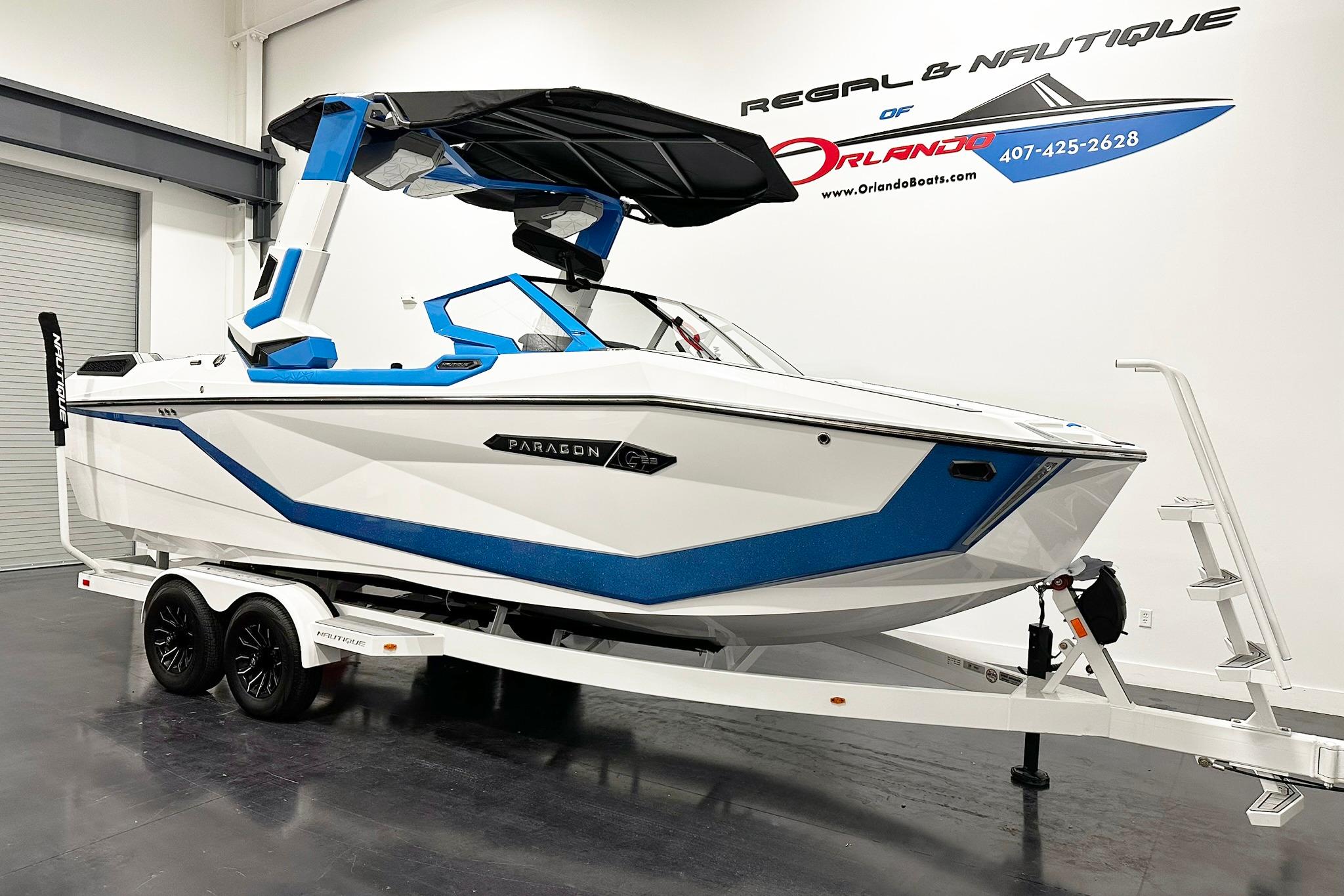 2025 Nautique Super Air Nautique G23 Paragon boat on trailer in showroom.