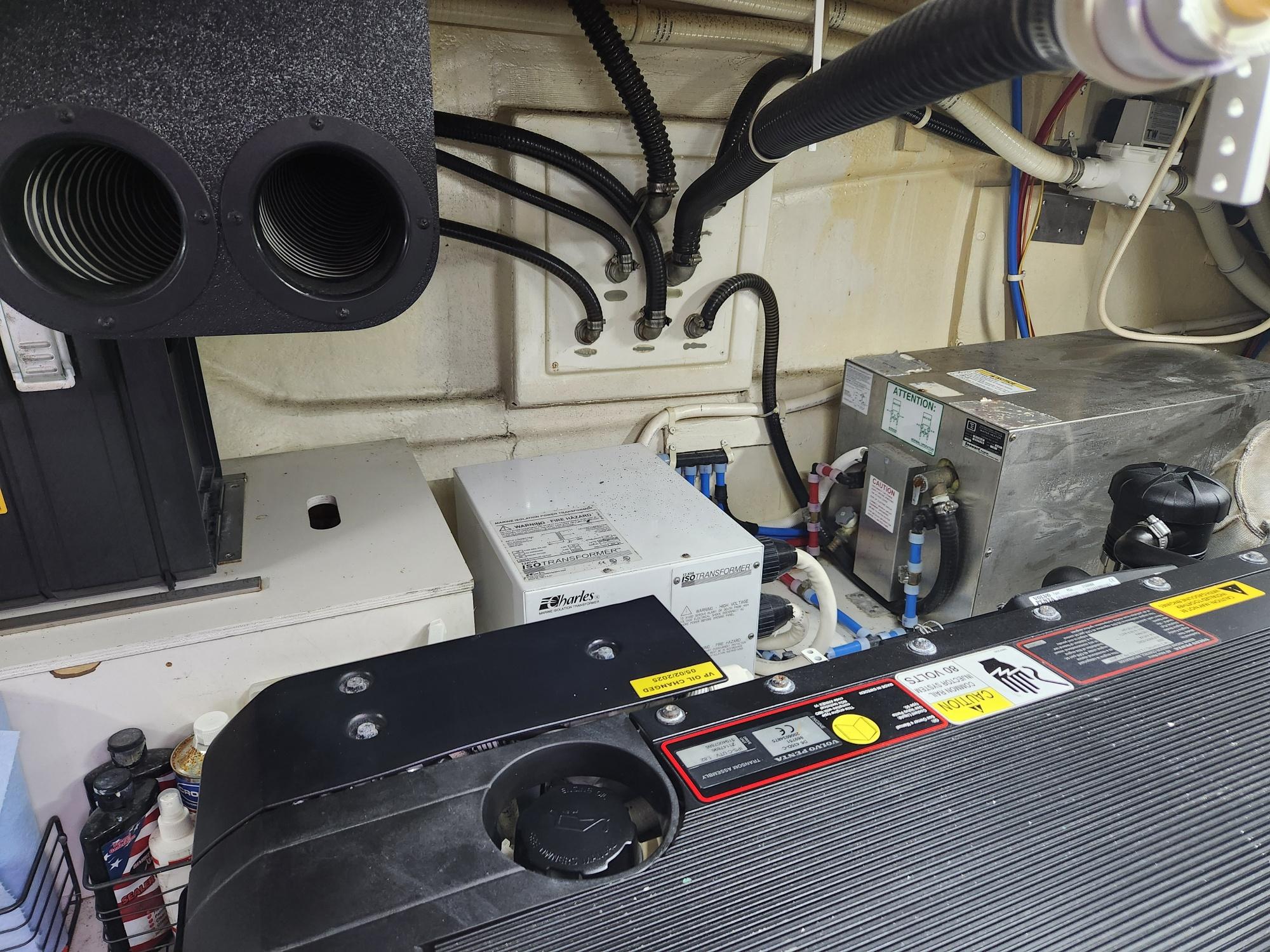 Engine room of a 2010 Marquis 500 SC yacht, featuring various mechanical components.