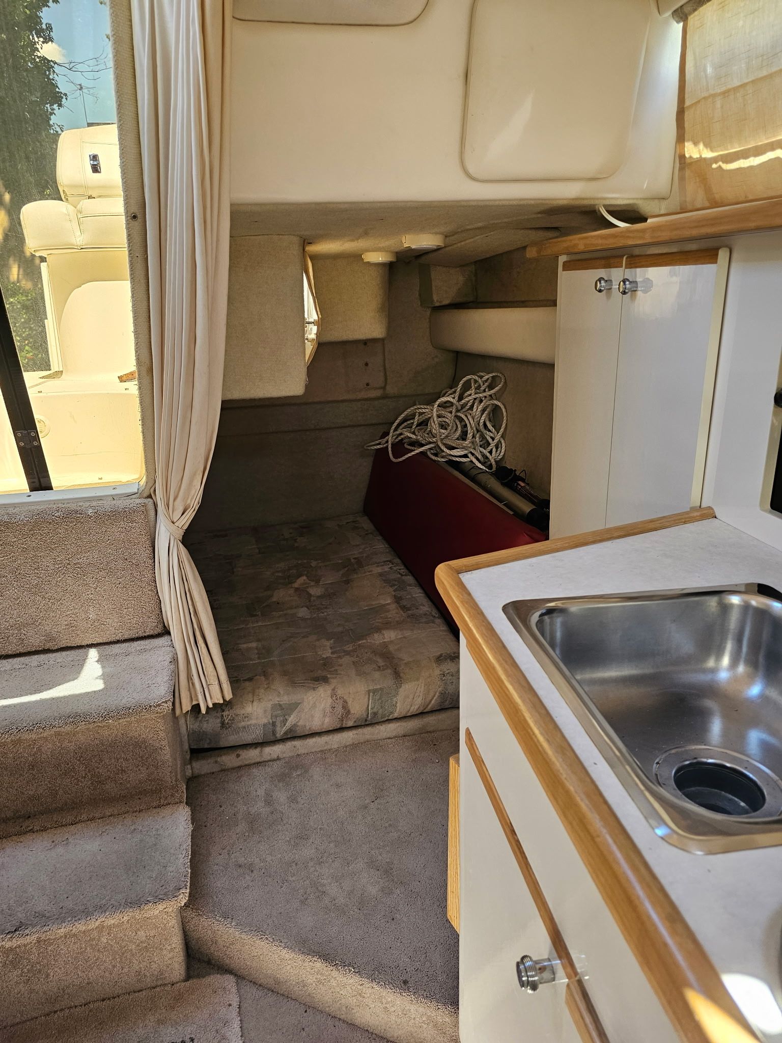 Interior of the 1998 Bayliner 2855 Ciera Sunbridge with kitchenette and sleeping area.