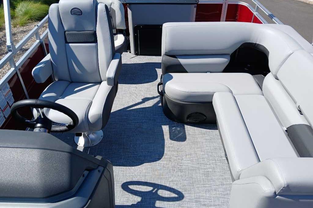 2026 Sun Tracker SportFish 20 DLX interior with plush seating and steering console.