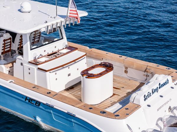 2020 HCB 53 Sueños boat on water, featuring spacious deck and American flag.