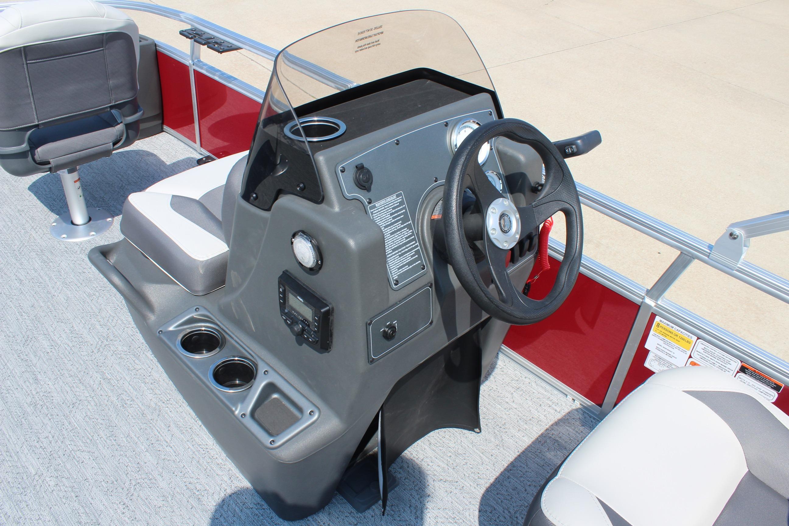 2026 Sun Tracker Bass Buggy 18 DLX boat console with steering wheel and seating.