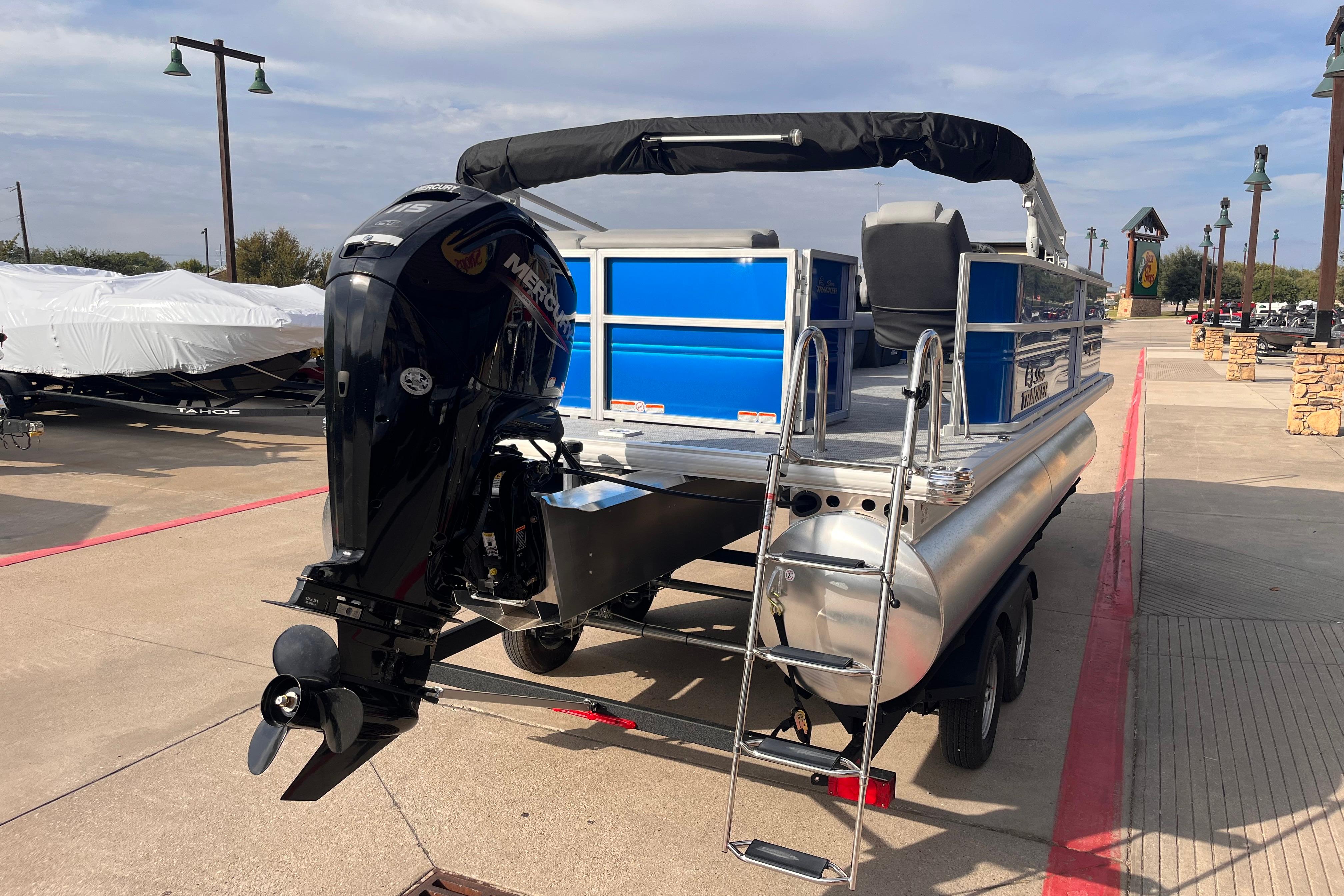 2026 Sun Tracker Party Barge 20 DLX pontoon boat with Mercury outboard motor.