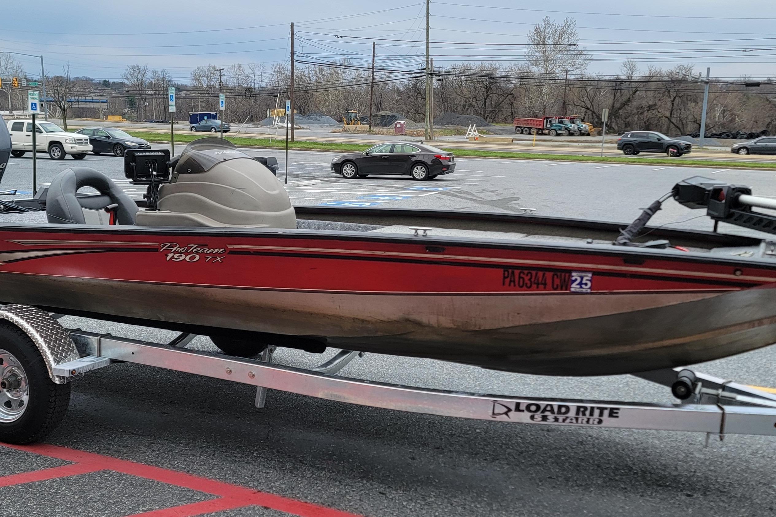 2006 Tracker Pro Team 190 TX boat on Load Rite trailer in parking lot.