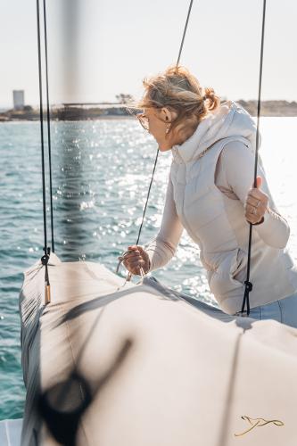 Woman enjoying sailing on 2025 Nautitech 44 Open catamaran in sunny weather.