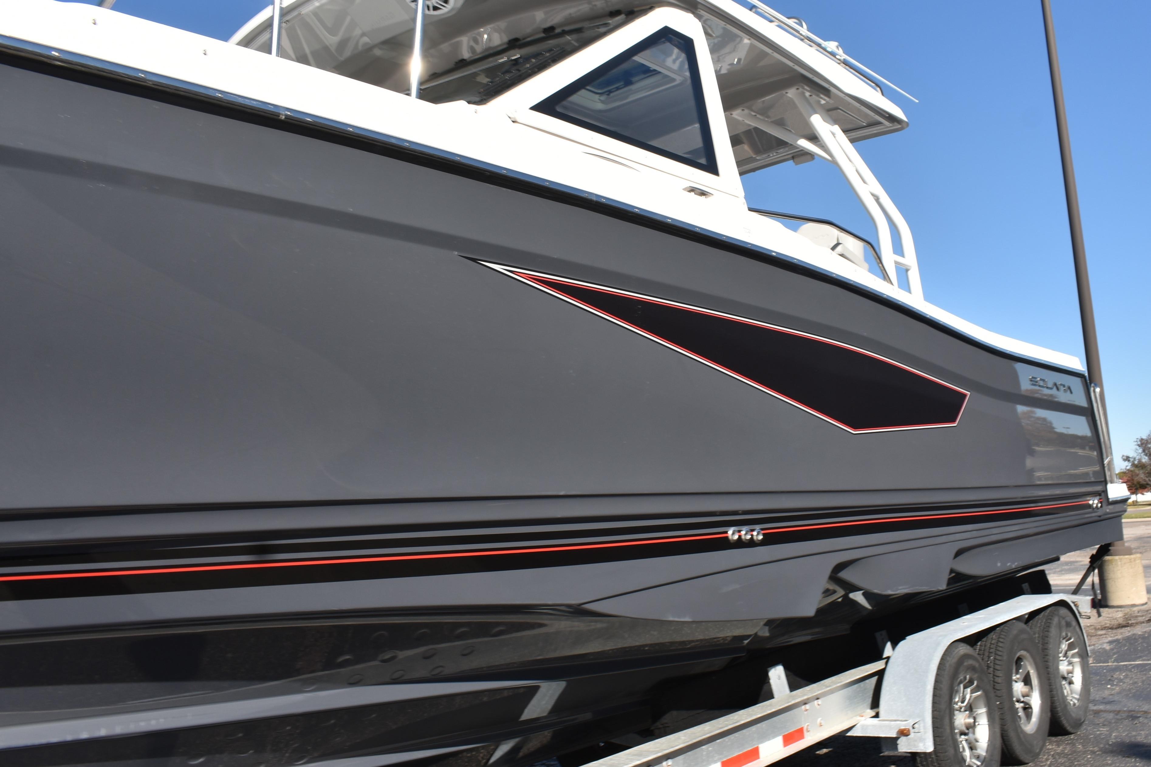 2025 Solara S-310 CW boat on trailer, sleek design with black and red accents.