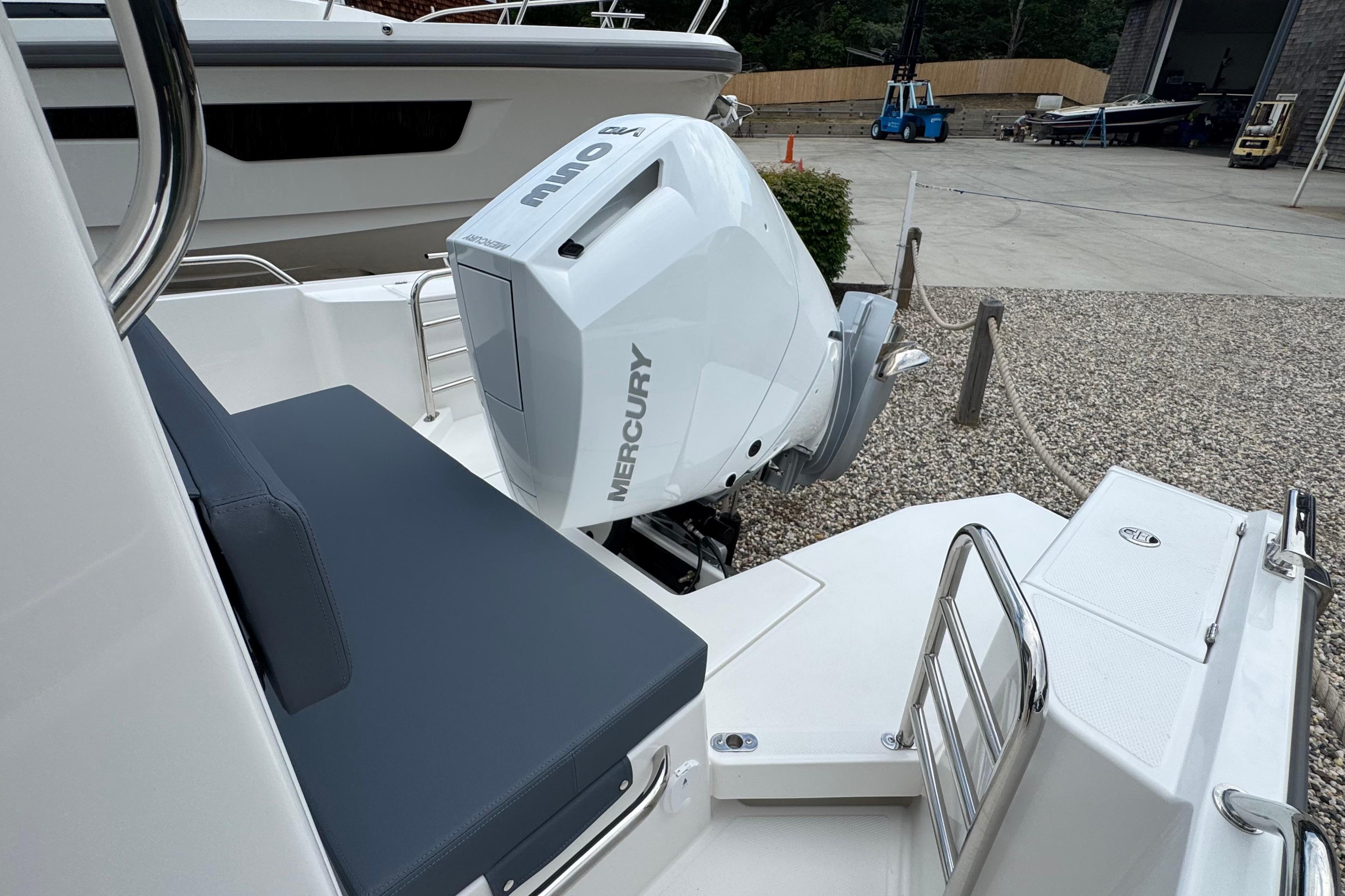 The image shows the stern of a Nimbus Commuter 9 boat with a Mercury outboard motor.
