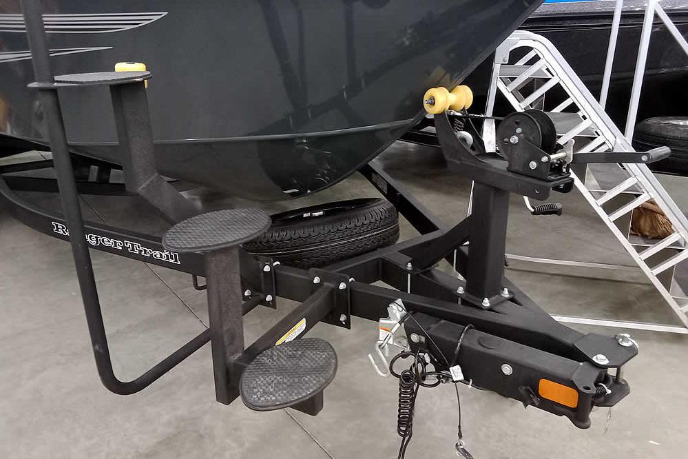 Trailer hitch and steps of 2026 Ranger VX1888 WT boat in showroom.