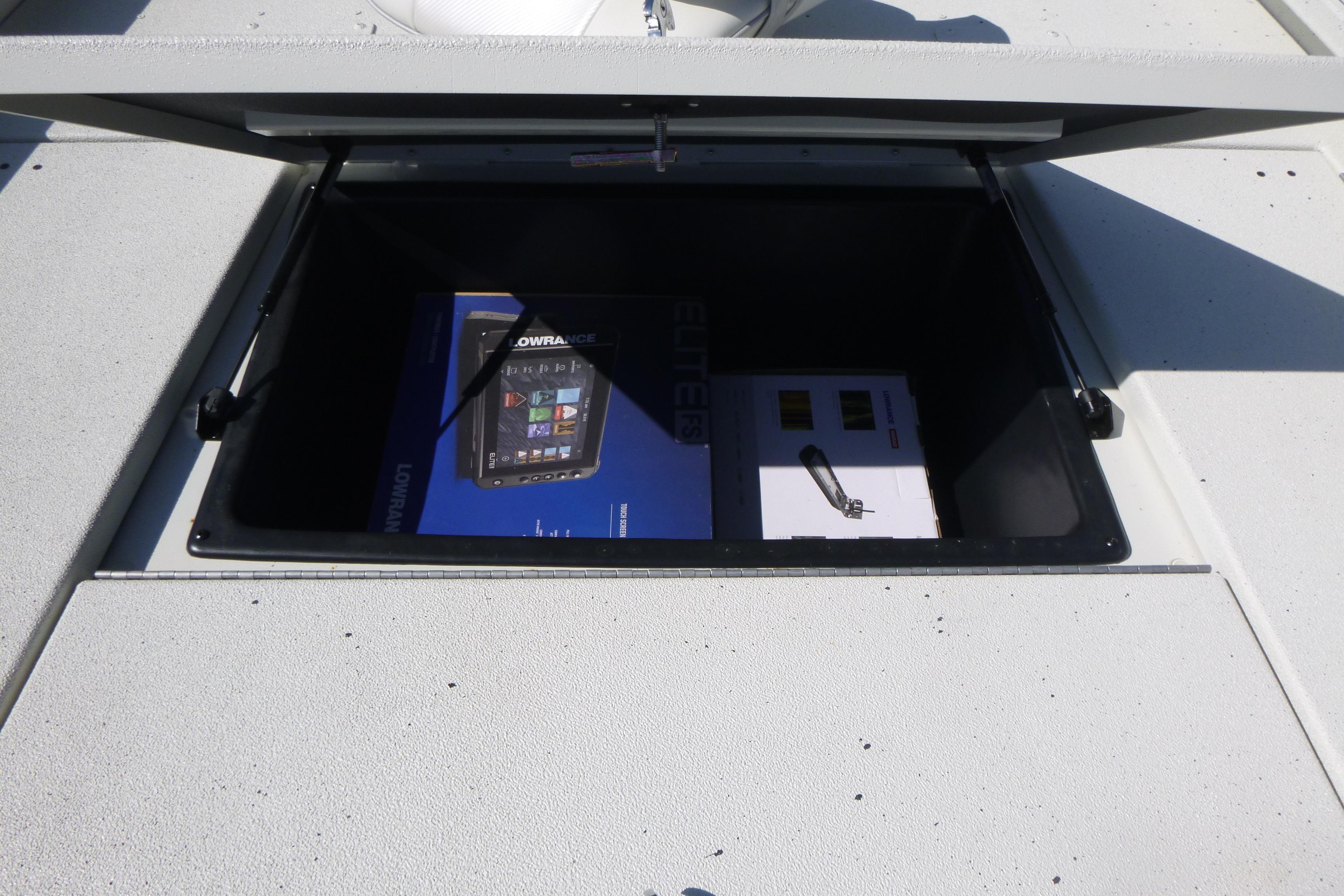 Open storage compartment on 2025 Ranger RB210 boat with electronic equipment inside.