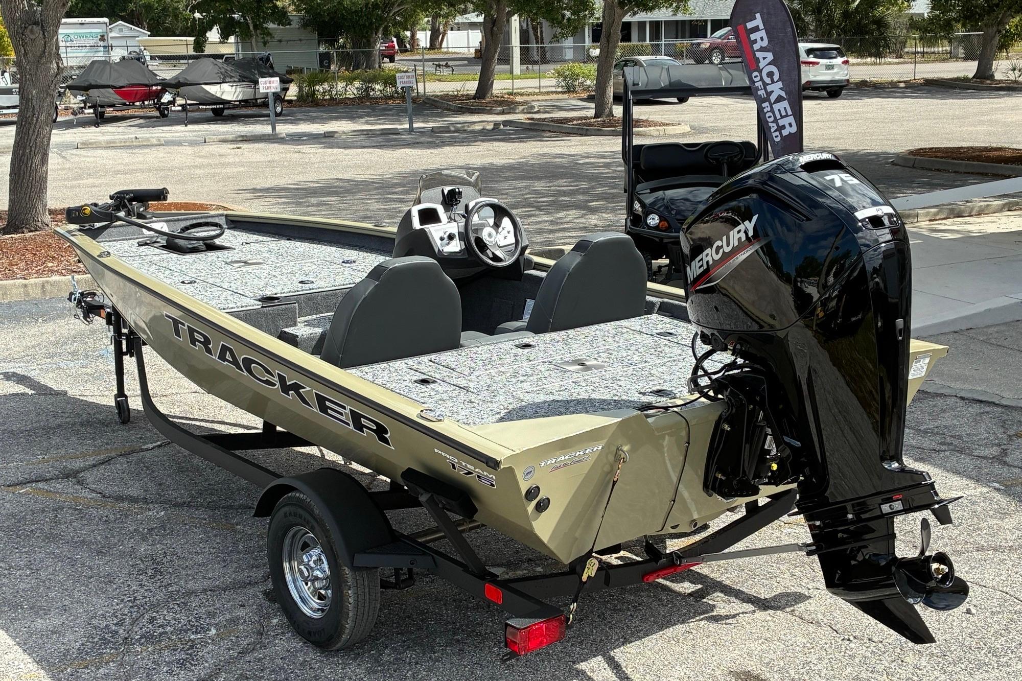 2026 Tracker Pro Team 175 boat with Mercury engine in a parking lot.