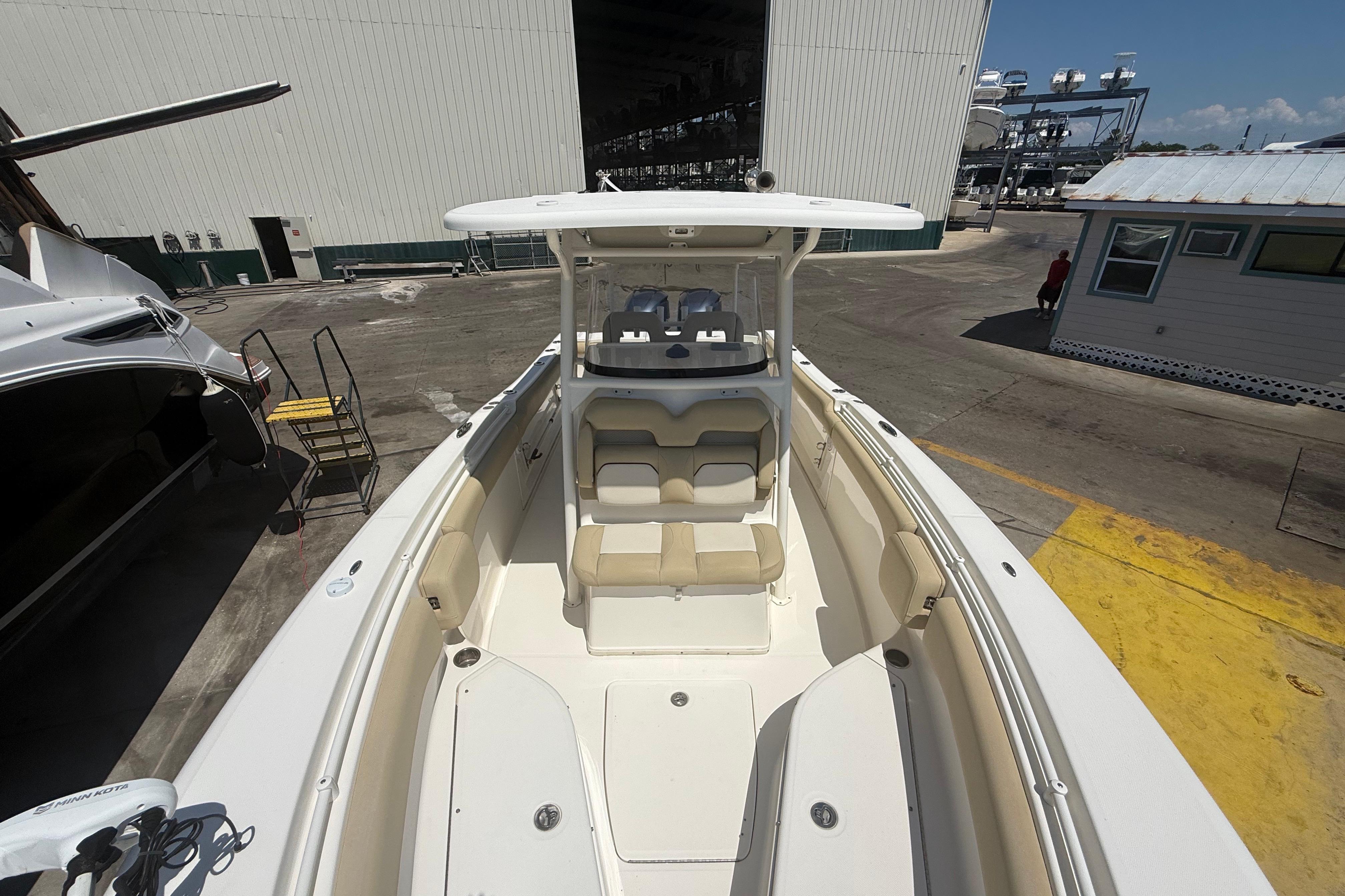 2019 Key West Billistic 281 Center Console boat at a marina, showcasing spacious seating.