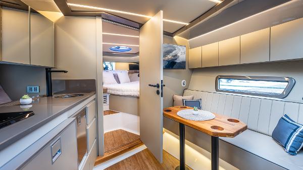 Luxurious interior of 2025 Hanover 415 yacht with modern kitchen and cozy seating area.