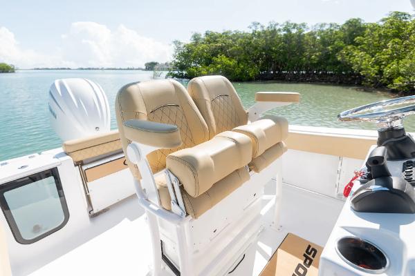 Manufacturer Provided Image: 2025 Sportsman Open 232 Center Console boat with tan seating, on a sunny day by the water.