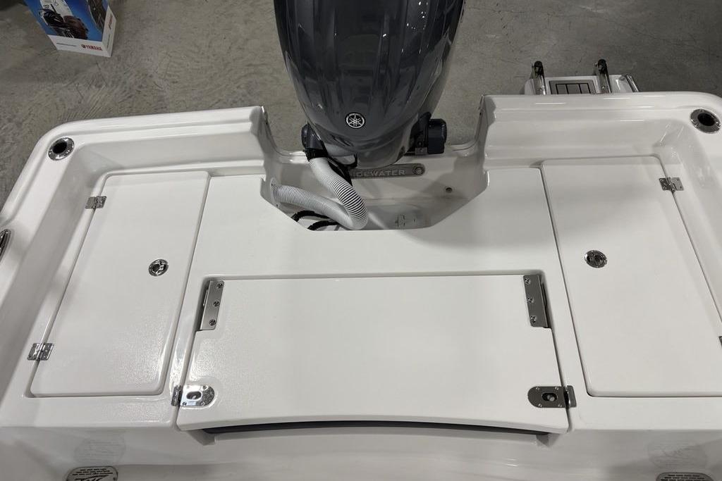 2026 Tidewater 2210 Carolina Bay boat's rear deck with motor and storage compartments.