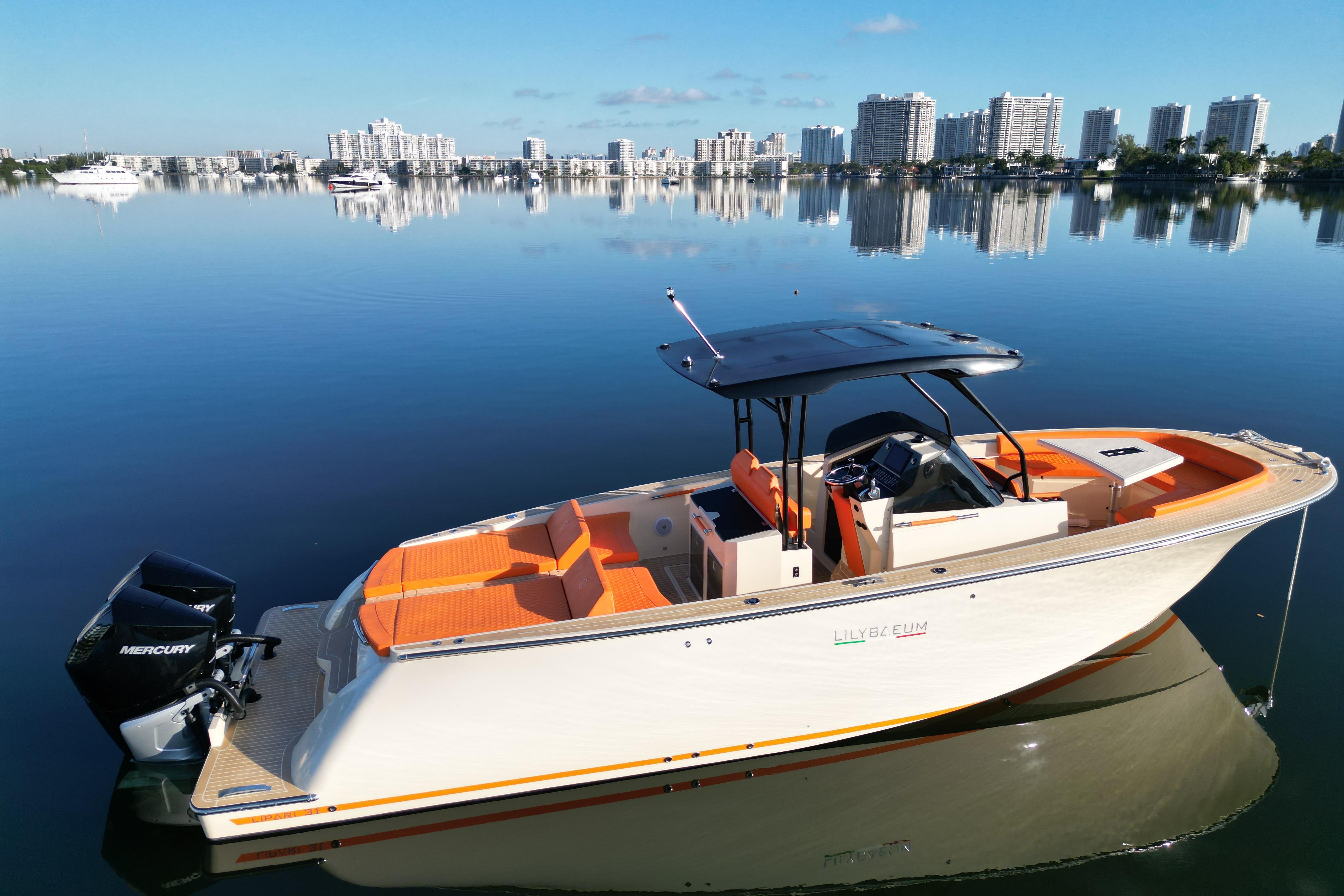2026 Lilybaeum Lipari 31 boat on calm water with city skyline in background.