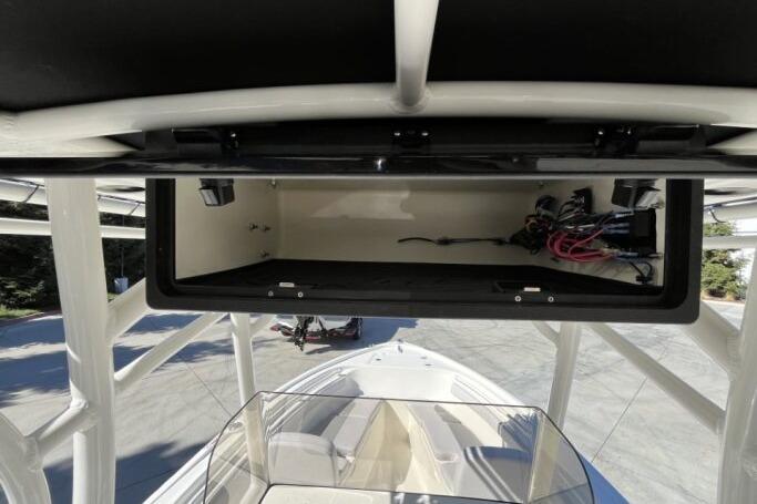 2025 Mako 214 Center Console boat with open storage compartment, showcasing interior wiring.