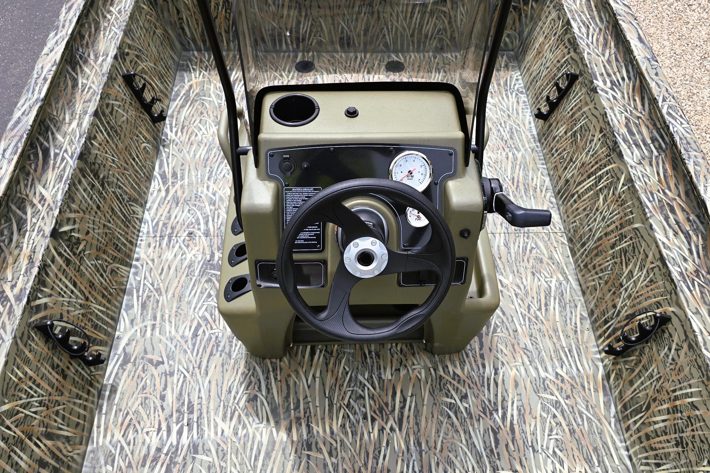 2026 Tracker Grizzly 1860 CC boat interior with camouflage design and steering console.