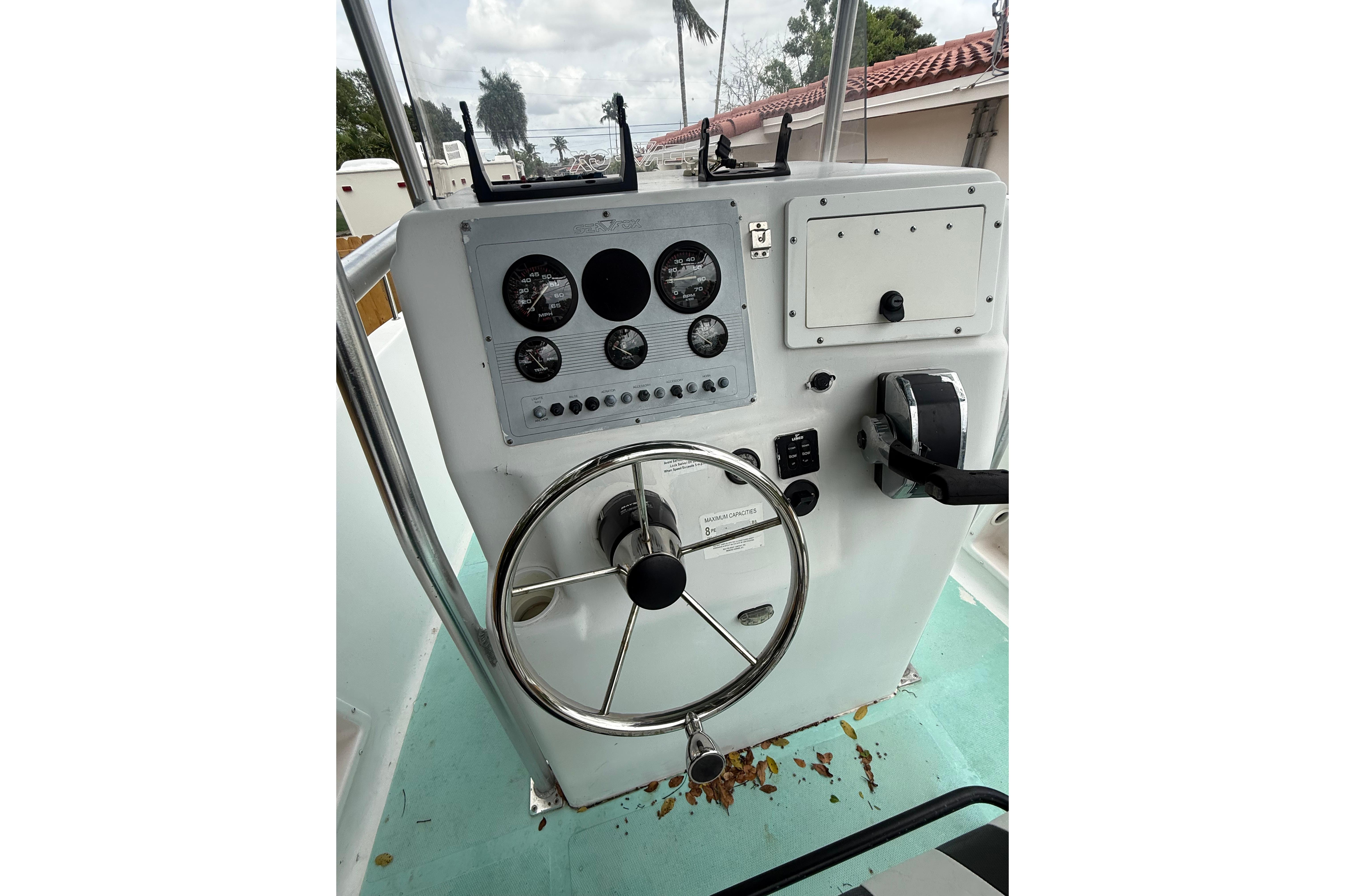 2005 LYG Sea Fox boat dashboard with steering wheel and control panel.