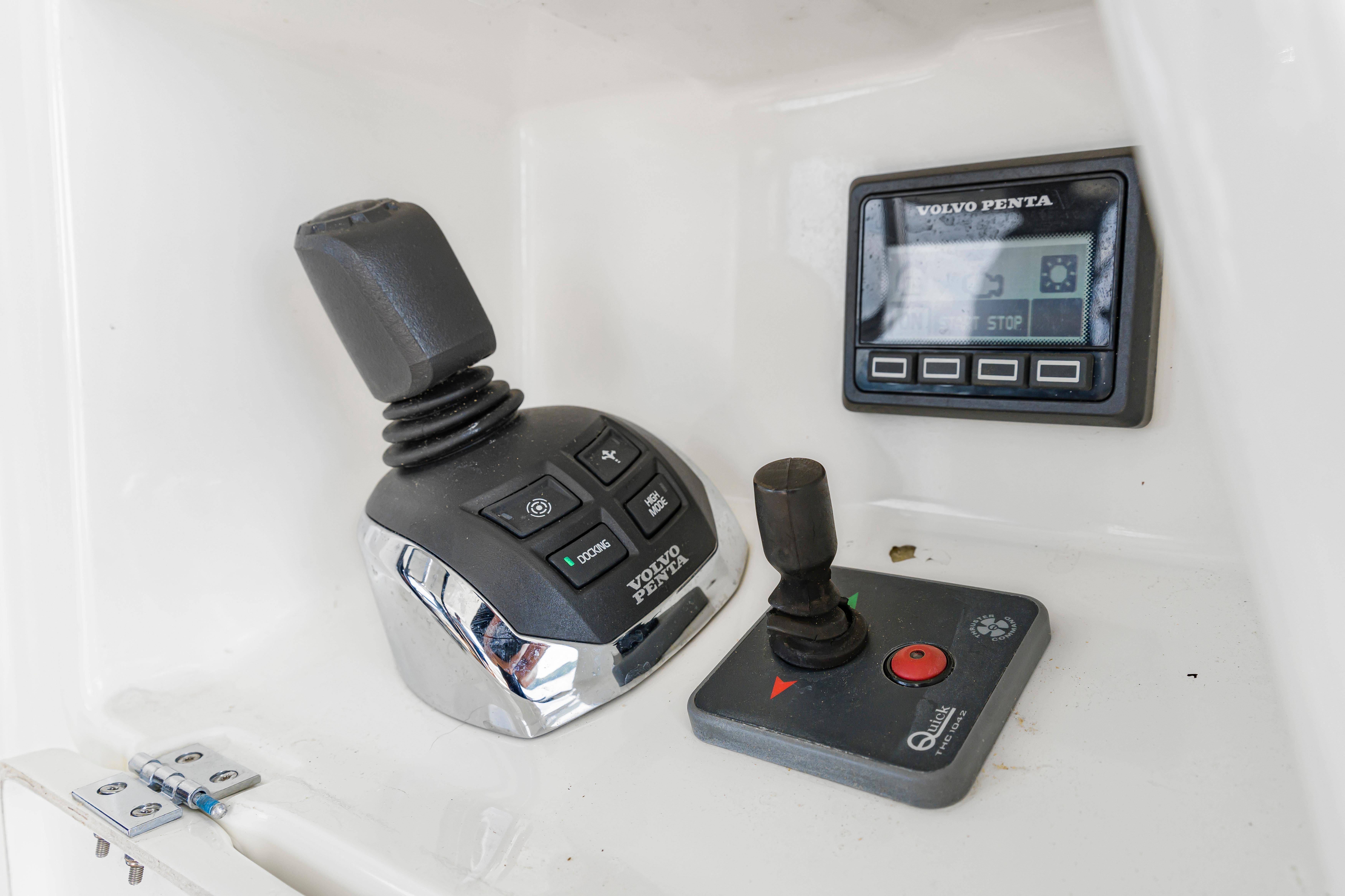 Control panel of a 2017 Prestige 500 yacht featuring joystick and Volvo Penta display.