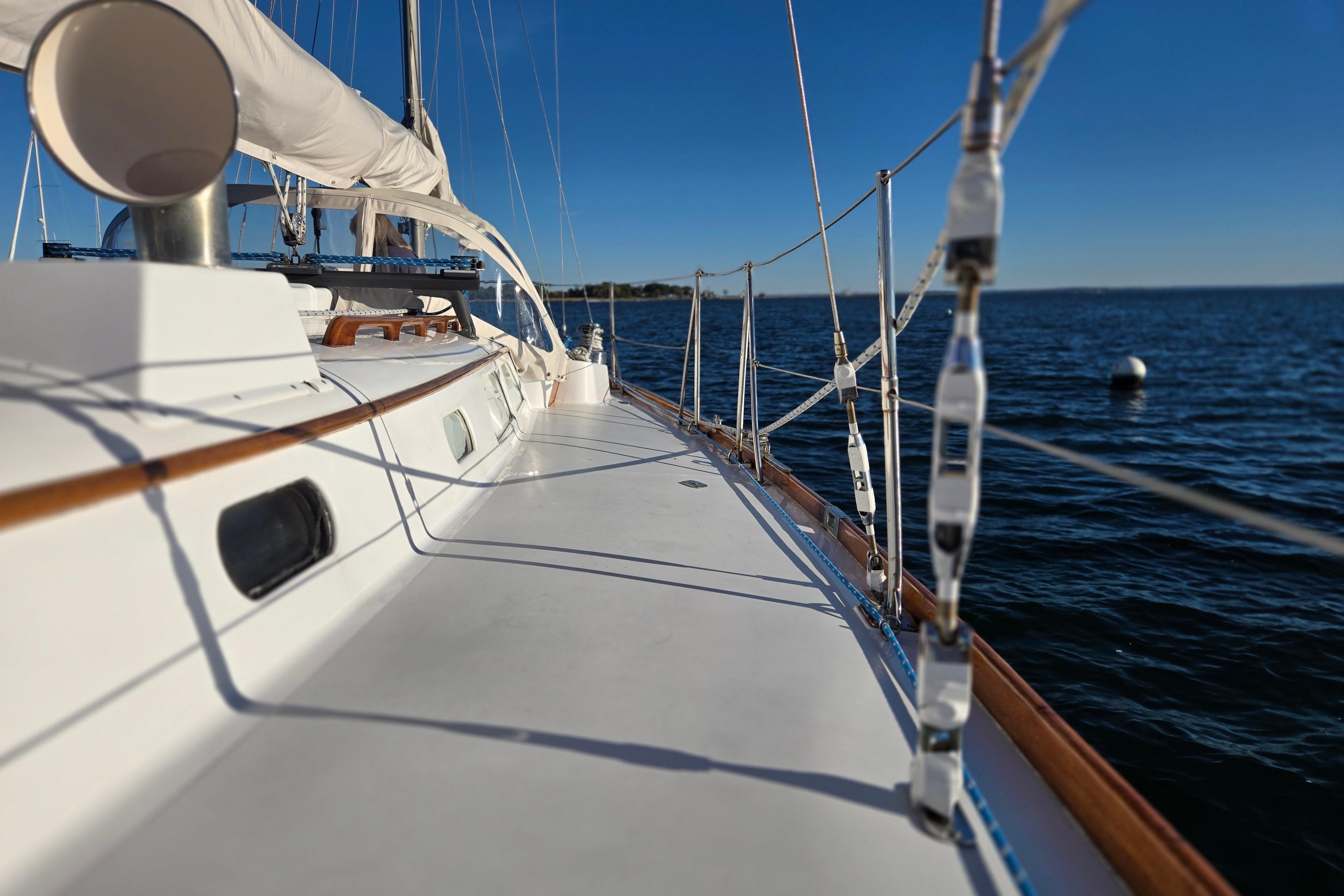 1970 Hinckley Bermuda 40 sailboat deck with ocean view, clear blue sky.