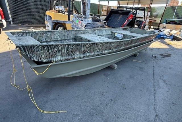 2026 Tracker Grizzly 15 Jon boat with camouflage design, parked outdoors.