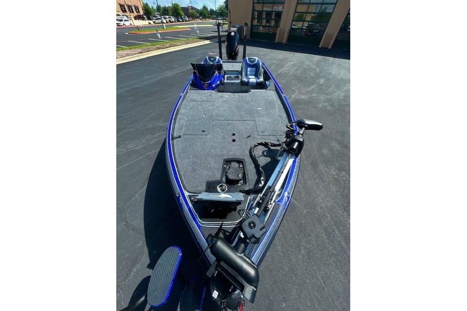 2026 Ranger Z521 boat with blue trim, parked on asphalt, featuring a spacious deck.