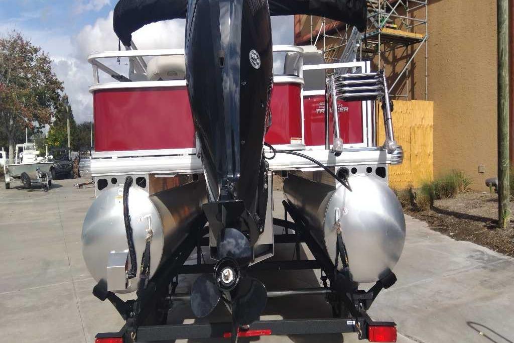 2026 Sun Tracker Bass Buggy 18 DLX pontoon boat, rear view with motor and ladder.