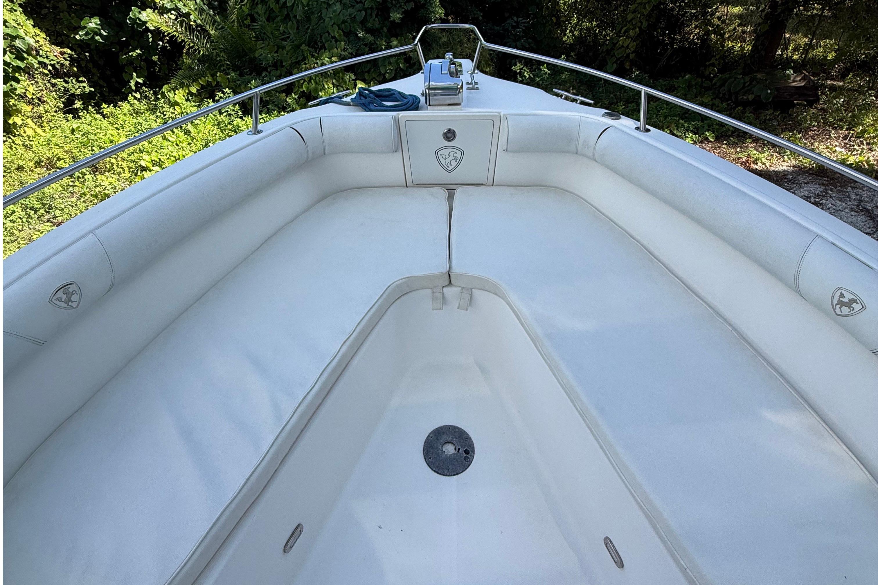 2008 Century 2901 Center Console boat with white cushioned seating and stainless steel railings.