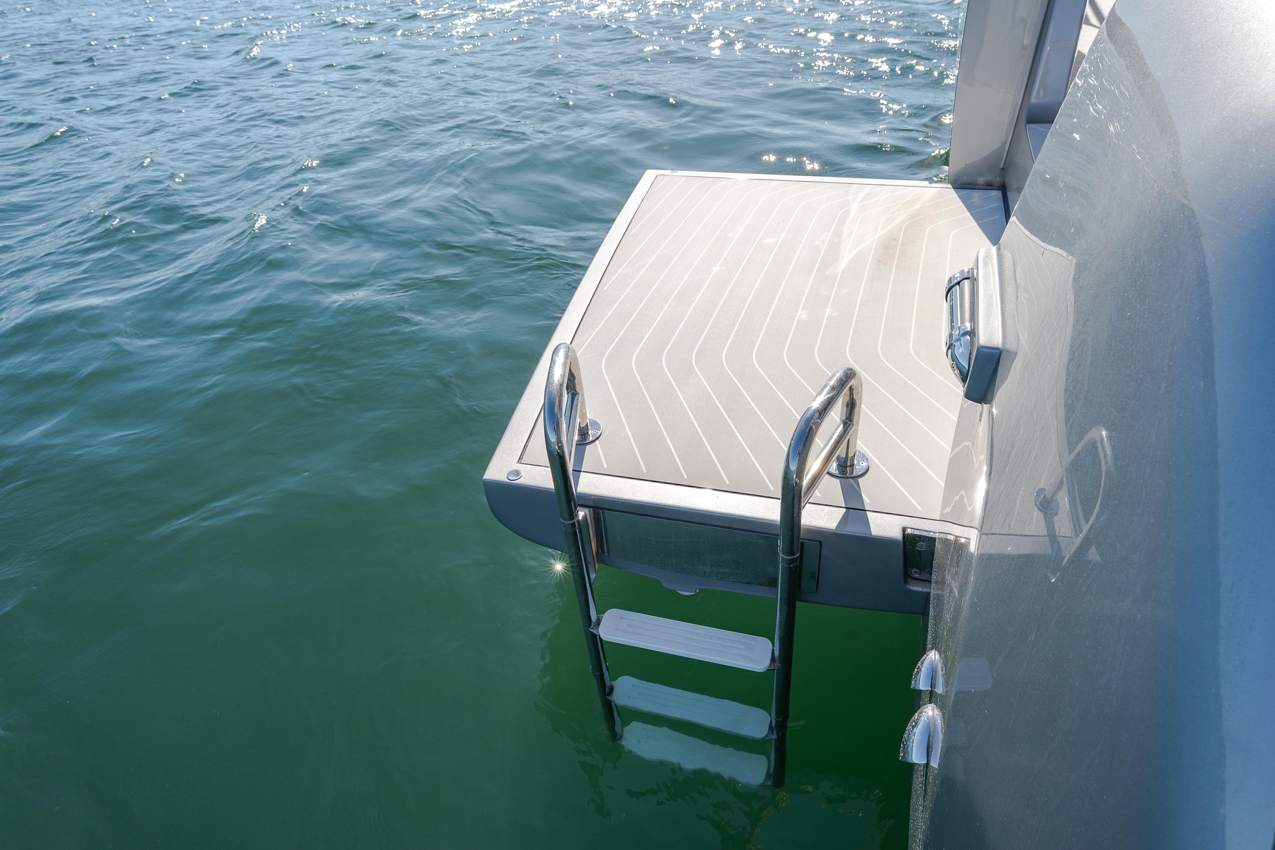 2023 Azimut Verve 47 swim platform with ladder on calm water.