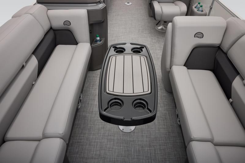 2026 Sun Tracker Party Barge 22 DLX interior with gray seating and central table.