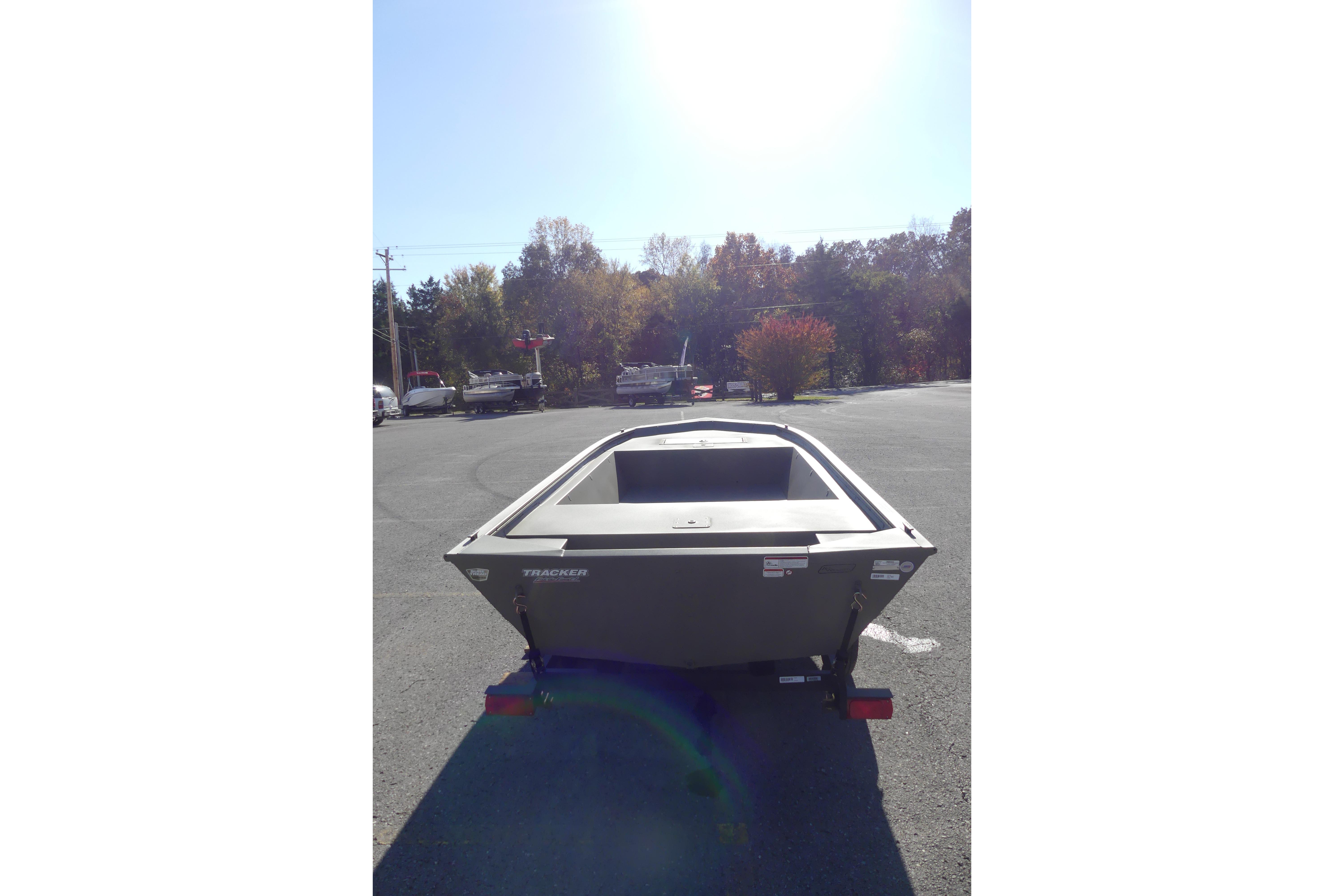2026 Tracker Grizzly 1648 Utility boat in a parking lot, rear view.