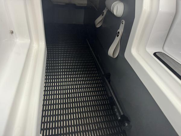 Interior view of a 2018 Monterey 258 Super Sport boat with black flooring.