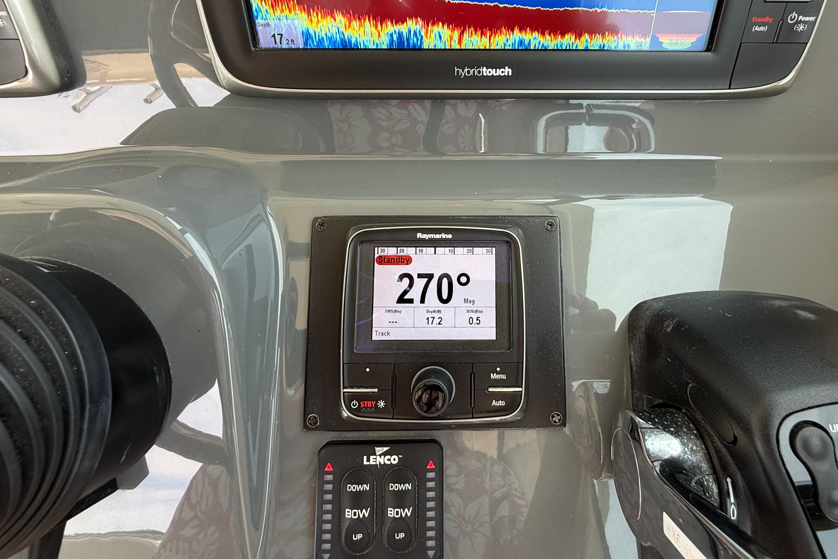 Control panel of a 2012 Pursuit OS 345 Offshore boat with navigation display.
