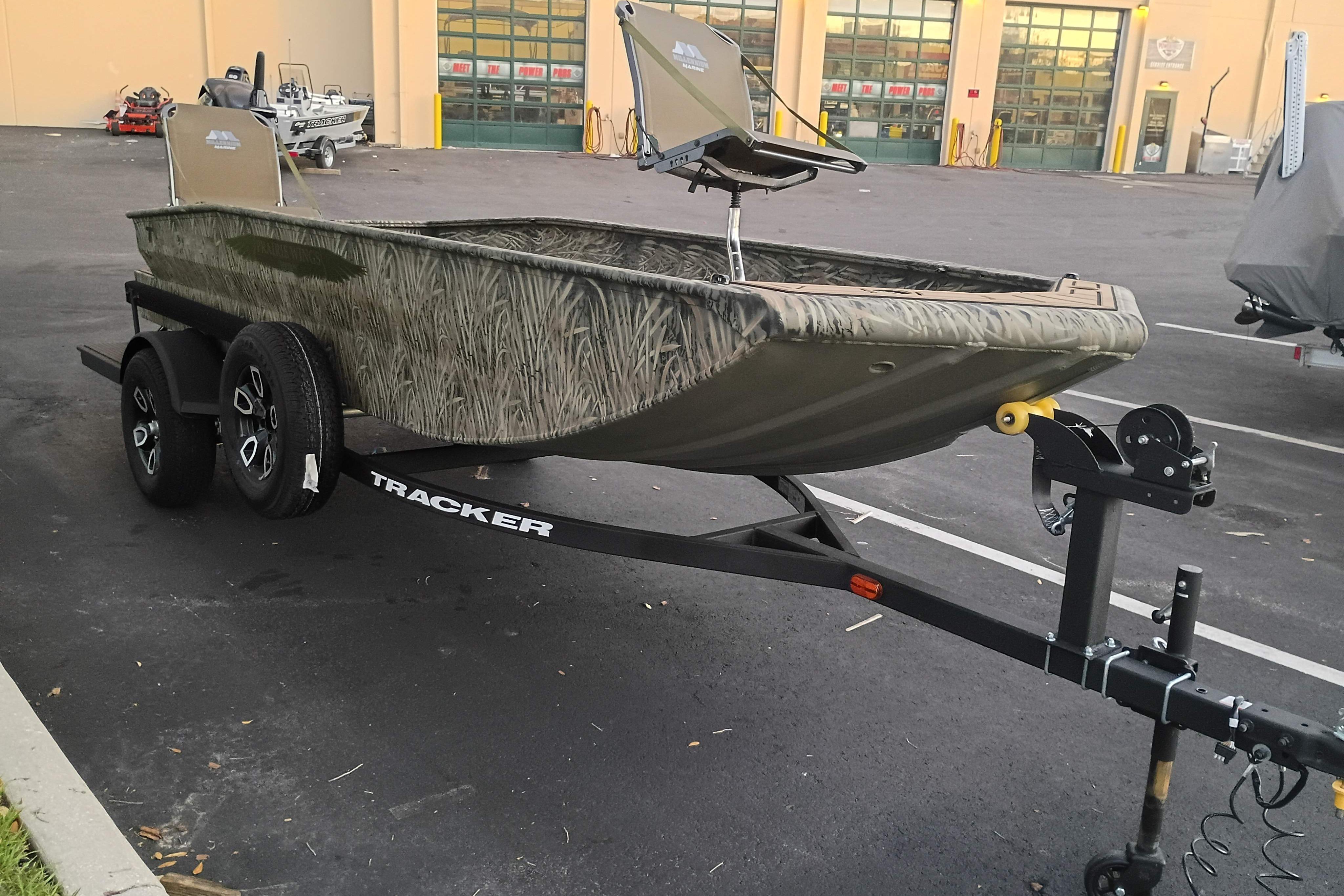 2026 Tracker Grizzly 1650 T Prairie Wings Edition boat on trailer in parking lot.
