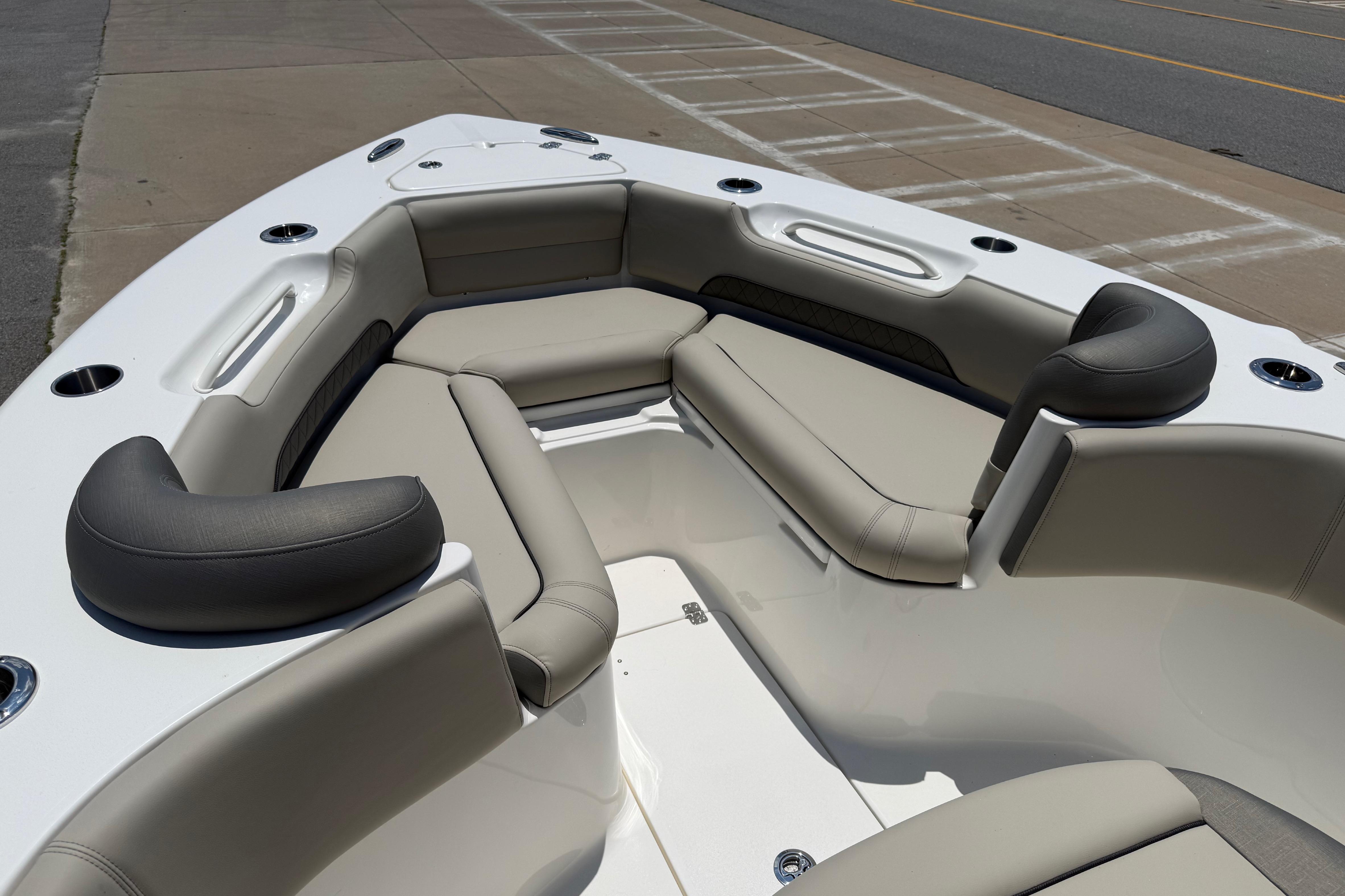 2027 Key West 249 FS boat interior with cushioned seating and cup holders.