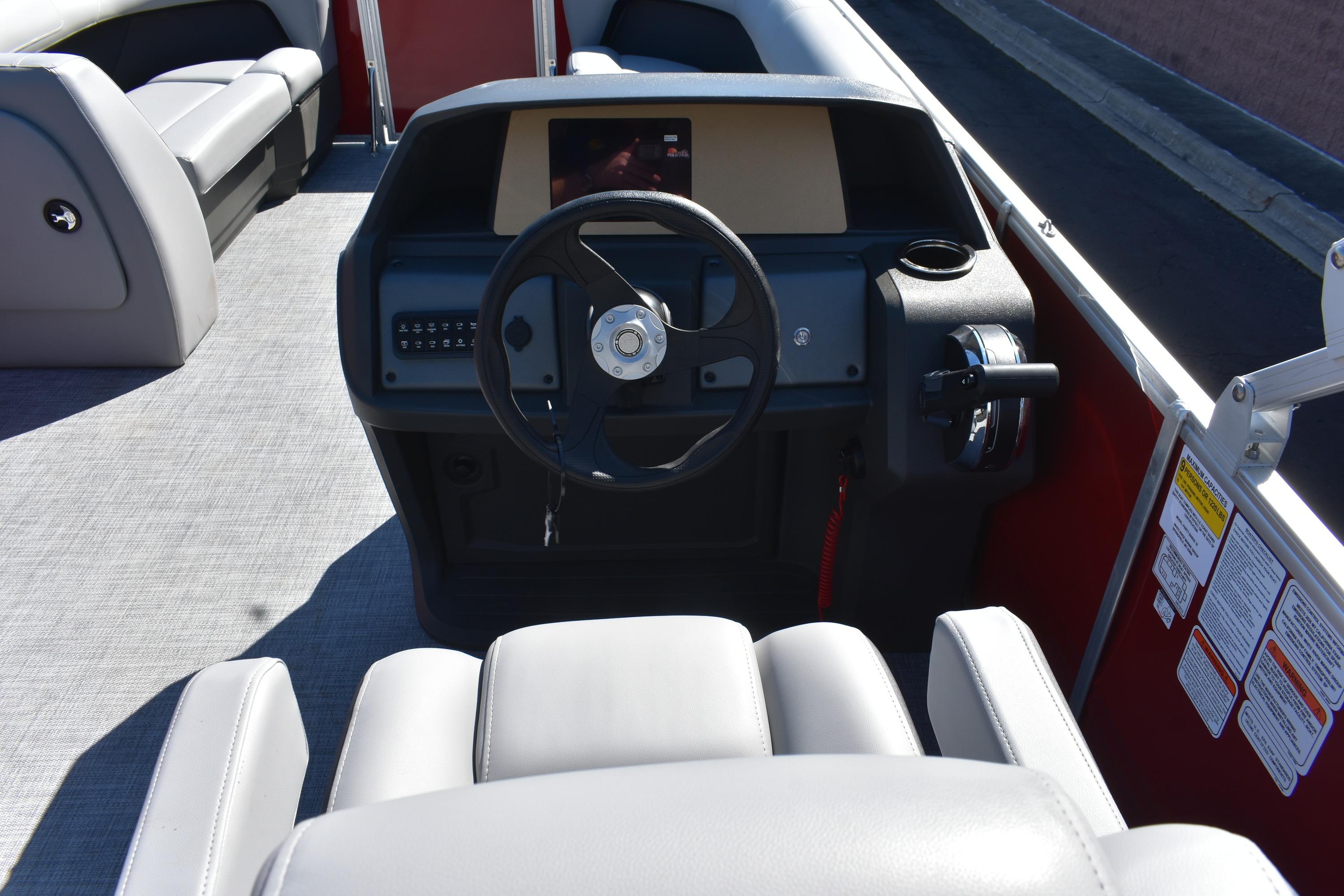2026 Sun Tracker Party Barge 18 DLX interior with steering wheel and seating.