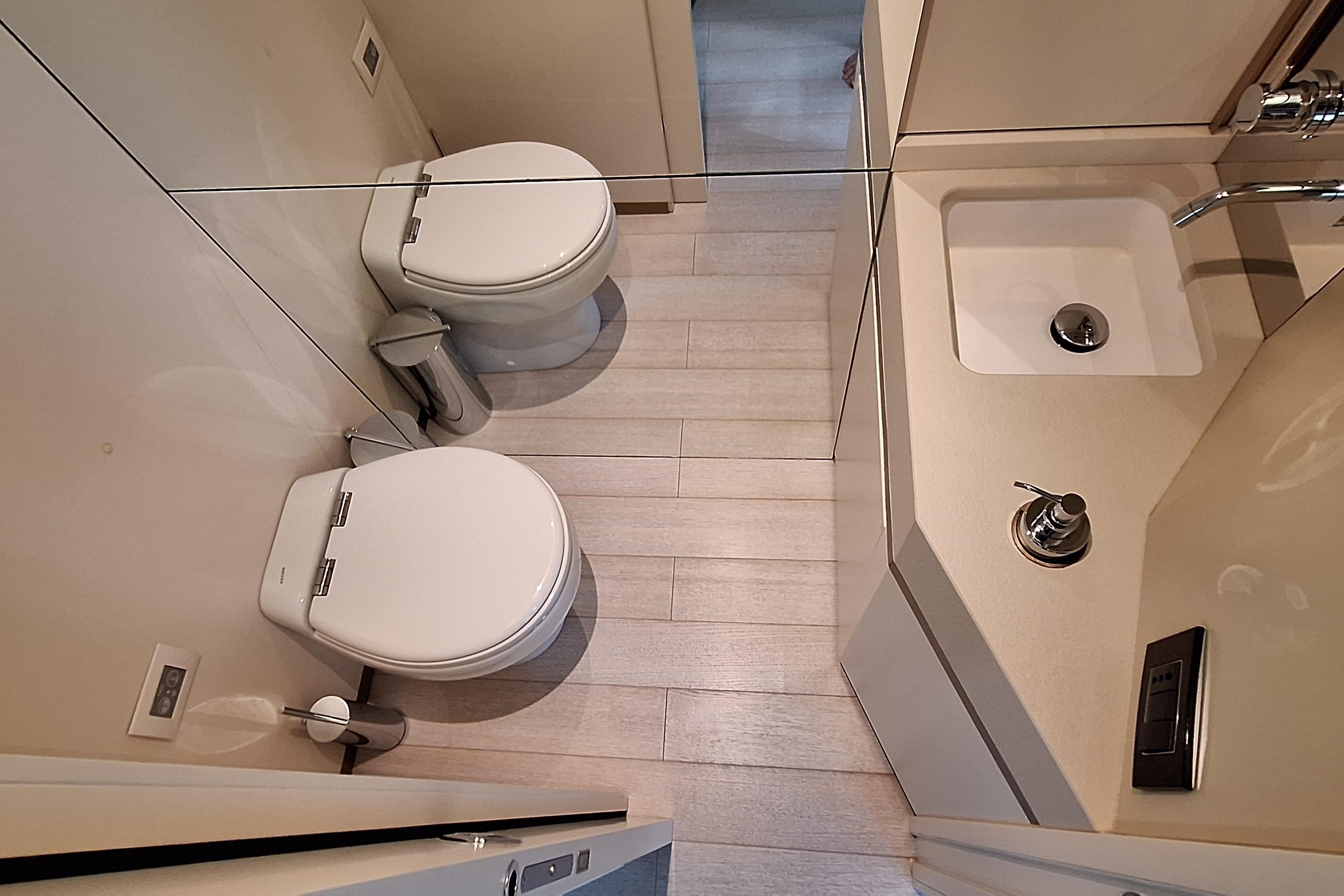 Luxurious bathroom in 2022 Azimut Magellano 25M yacht, featuring modern fixtures and elegant design.